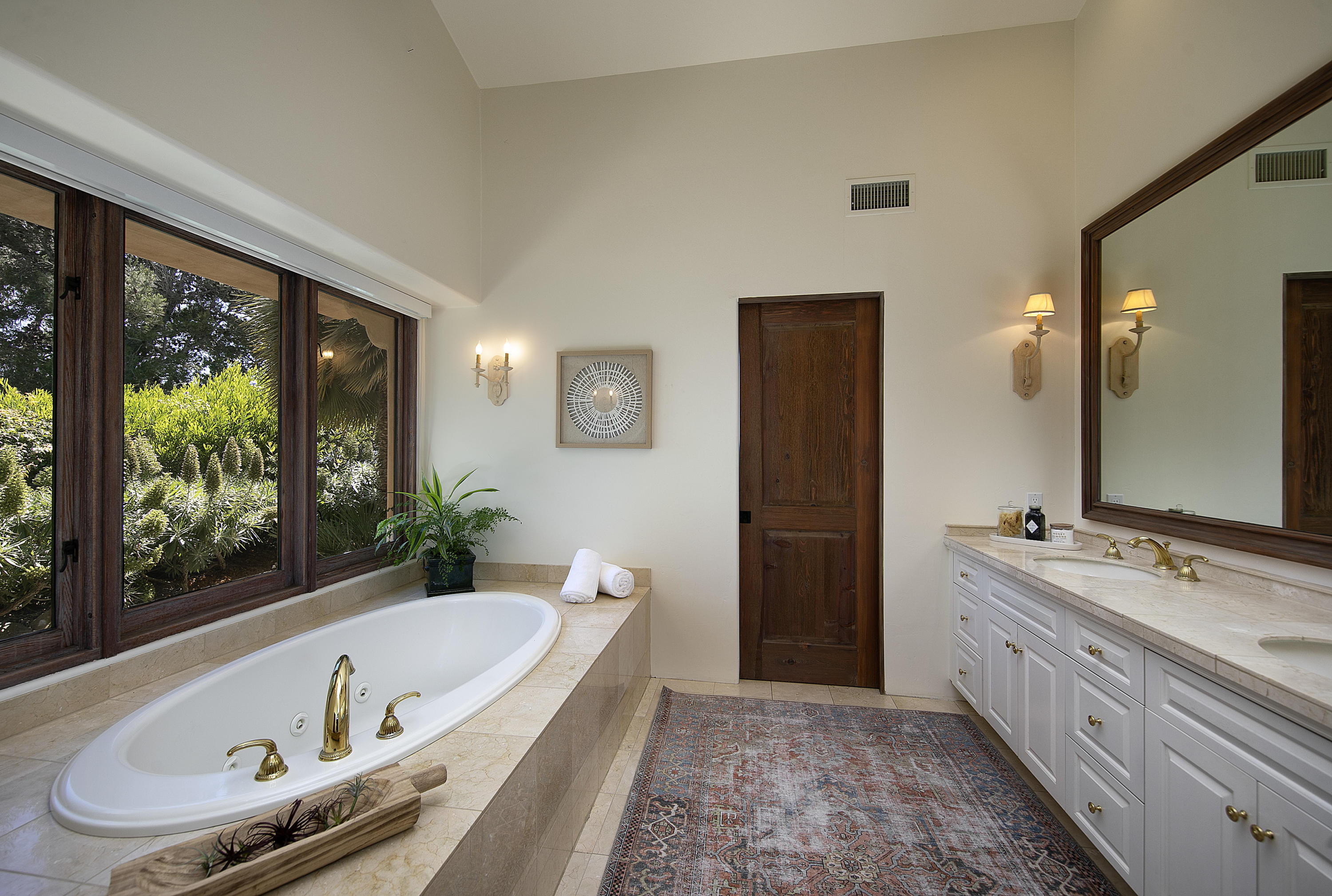 2250 Ortega Ranch Road Summerland, CA 93067 - Photo 19 of 28 a bathroom with a tub a sink and a large mirror