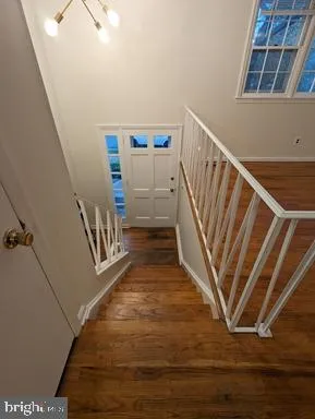 a view of entryway and hall with wooden floor