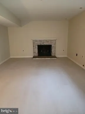 a view of empty room with a fireplace