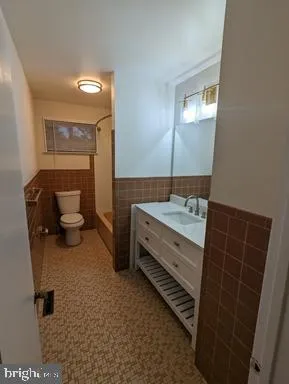 a bathroom with a double vanity sink and a toilet