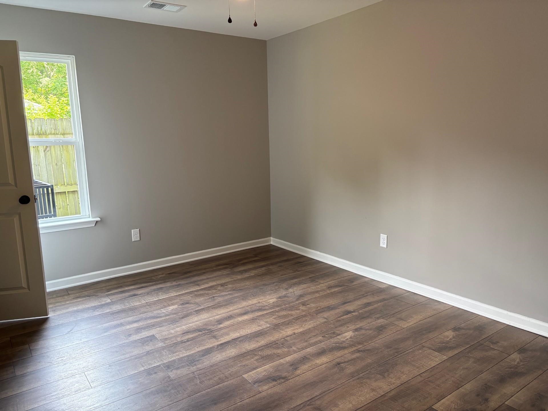 3701 Whittier Road Memphis, TN 38108 - Photo 8 of 13 Empty room with dark wood-type flooring