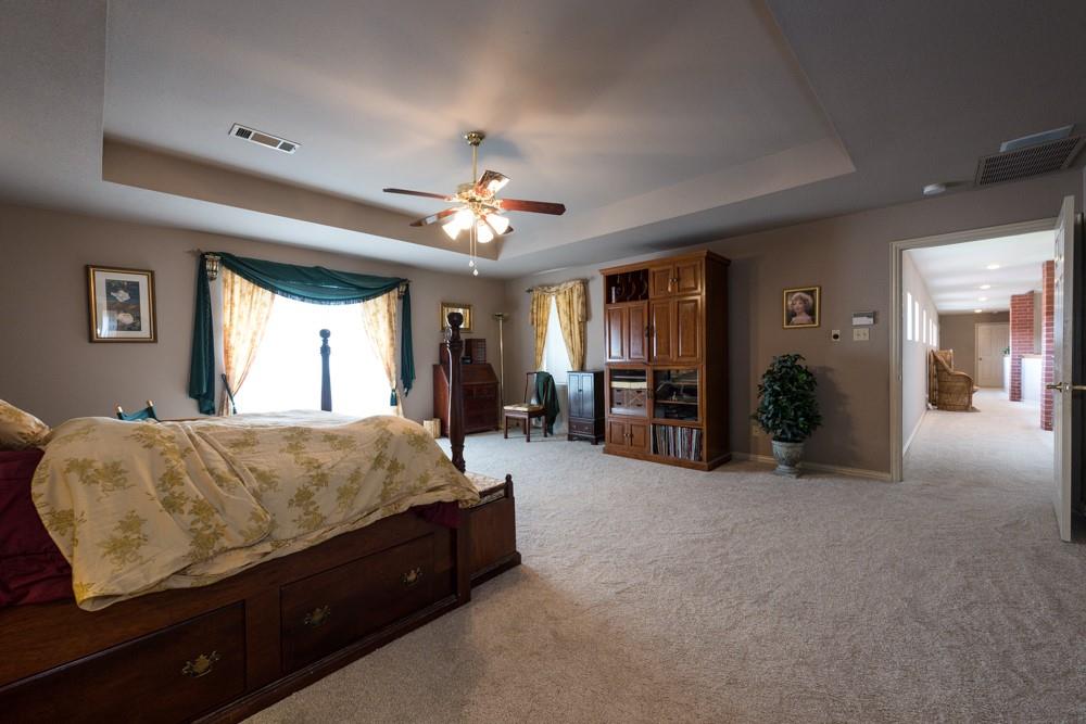 9554 David Fort Road Argyle, TX 76226 - Photo 25 of 35 a bed room with a bed and a chandelier