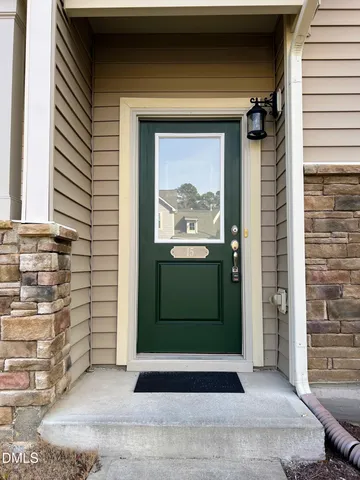 a front view of a house with cars parked