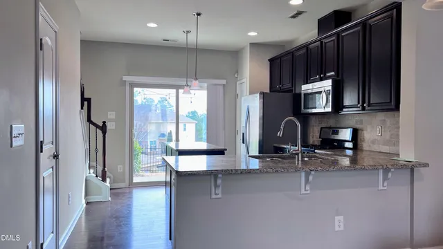 a kitchen with center island and chandelier