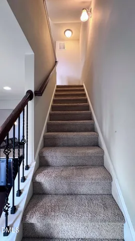 a view of an empty room with stairs