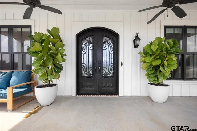 a hallway with painting and a rug