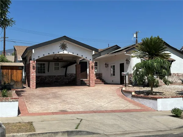 a view of a house with palm trees