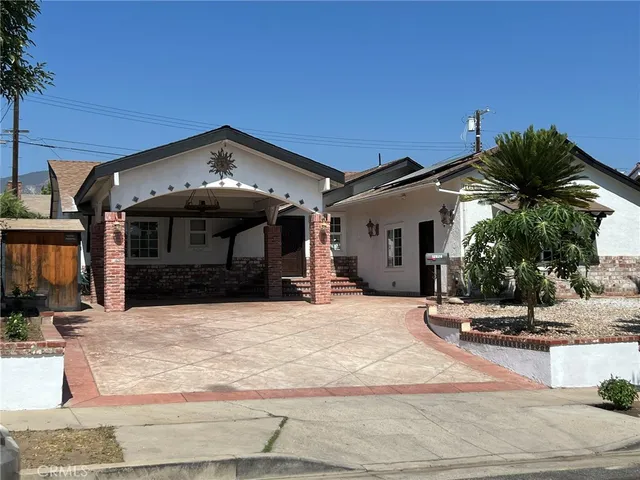 a view of a house with palm trees