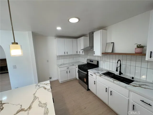 a kitchen with a sink stove and cabinets