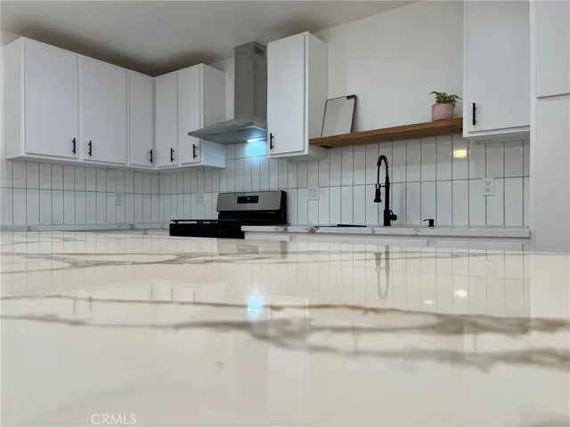 a kitchen with stainless steel appliances granite countertop a sink and cabinets