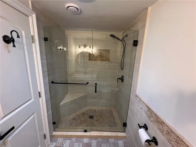 a bathroom with a glass shower door