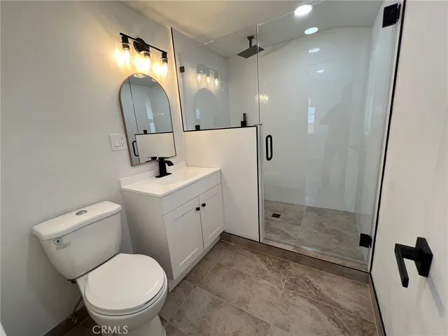 a bathroom with a toilet sink and shower