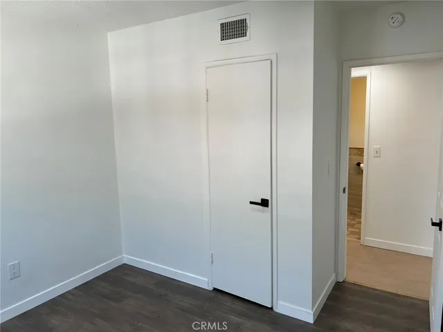 an empty room with wooden floor