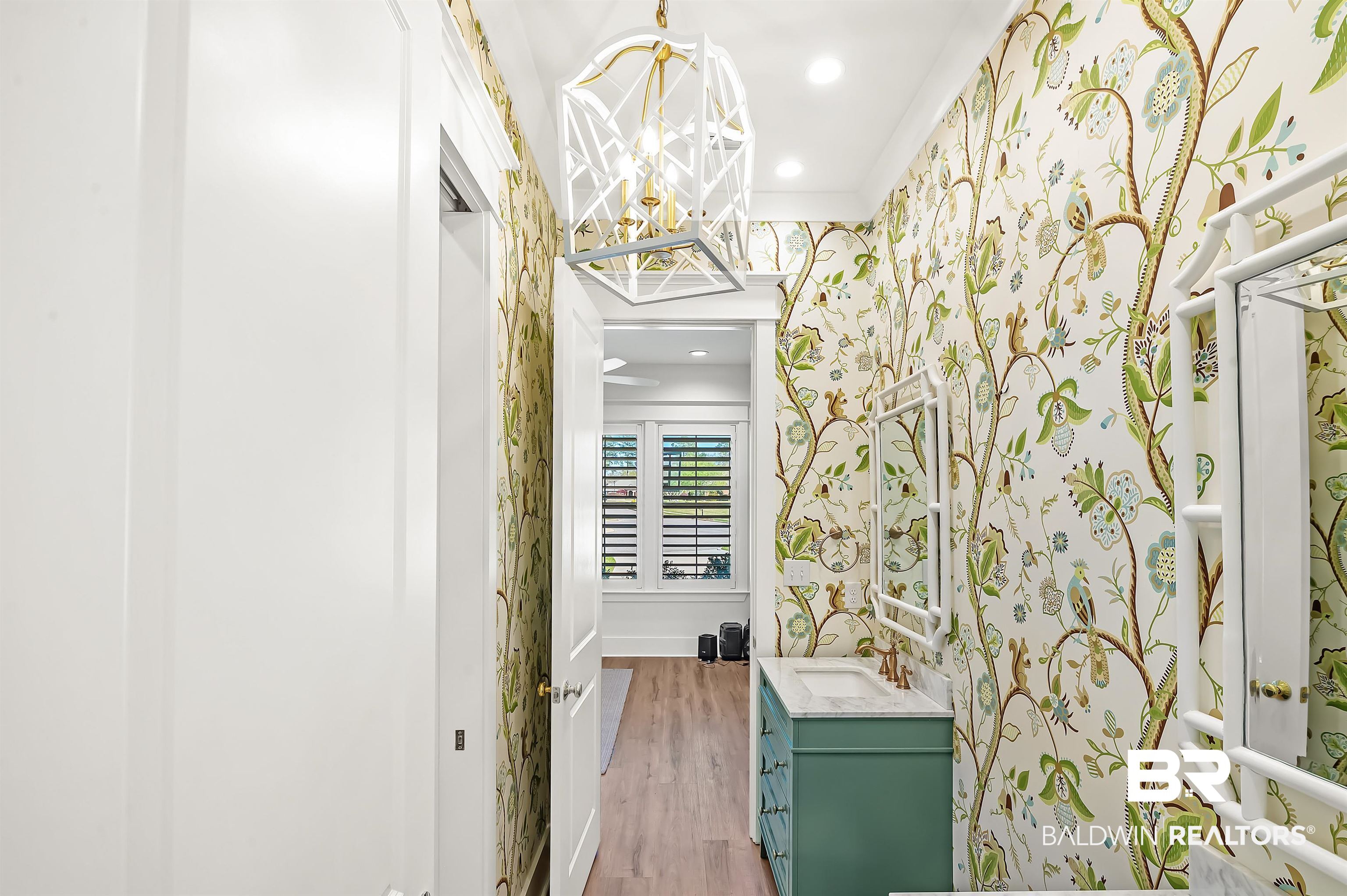 27888 Oakachoy Loop Daphne, AL 36526 - Photo 37 of 65 Corridor with recessed lighting, an inviting chandelier, ornamental molding, wallpapered walls, and light wood-style floors