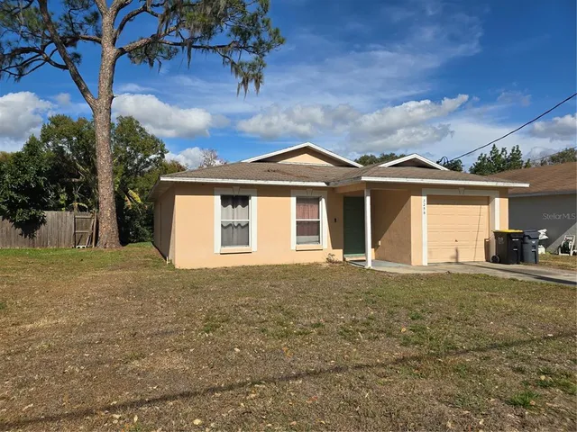 a front view of a house with a garden and yard