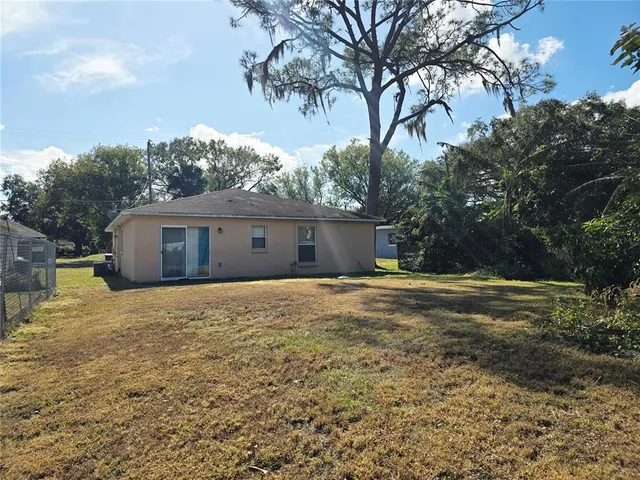 a front view of house with yard and trees