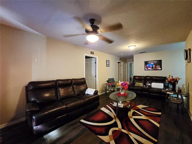 a living room with furniture and wooden floor