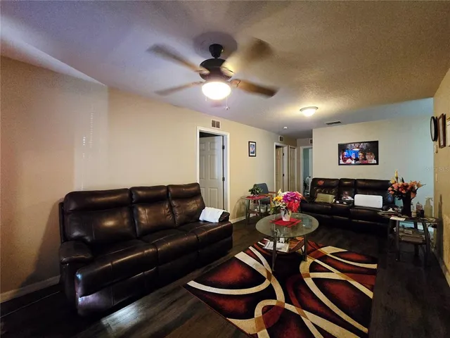 a living room with furniture and wooden floor