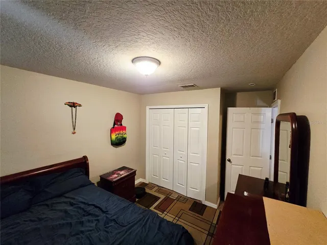 a bedroom with a bed and a mirror