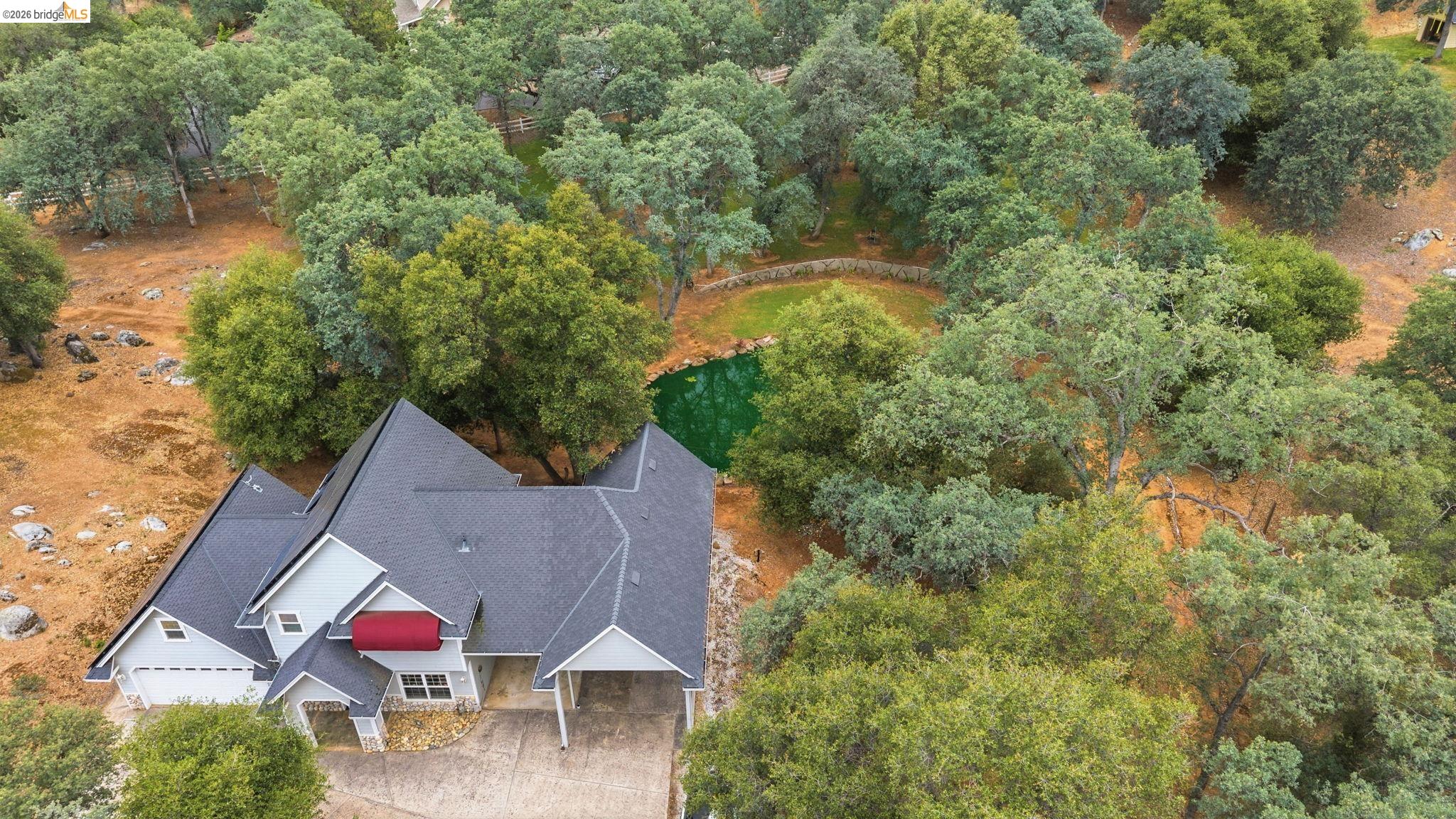18450 Lambert Lake Road Sonora, CA 95370 - Photo 85 of 87 Contemporary residence with a multi-gabled roofline and a red awning accent