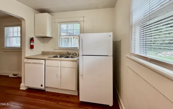 a white refrigerator freezer sitting inside of a kitchen