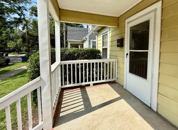 a view of a porch with wooden floor and fence