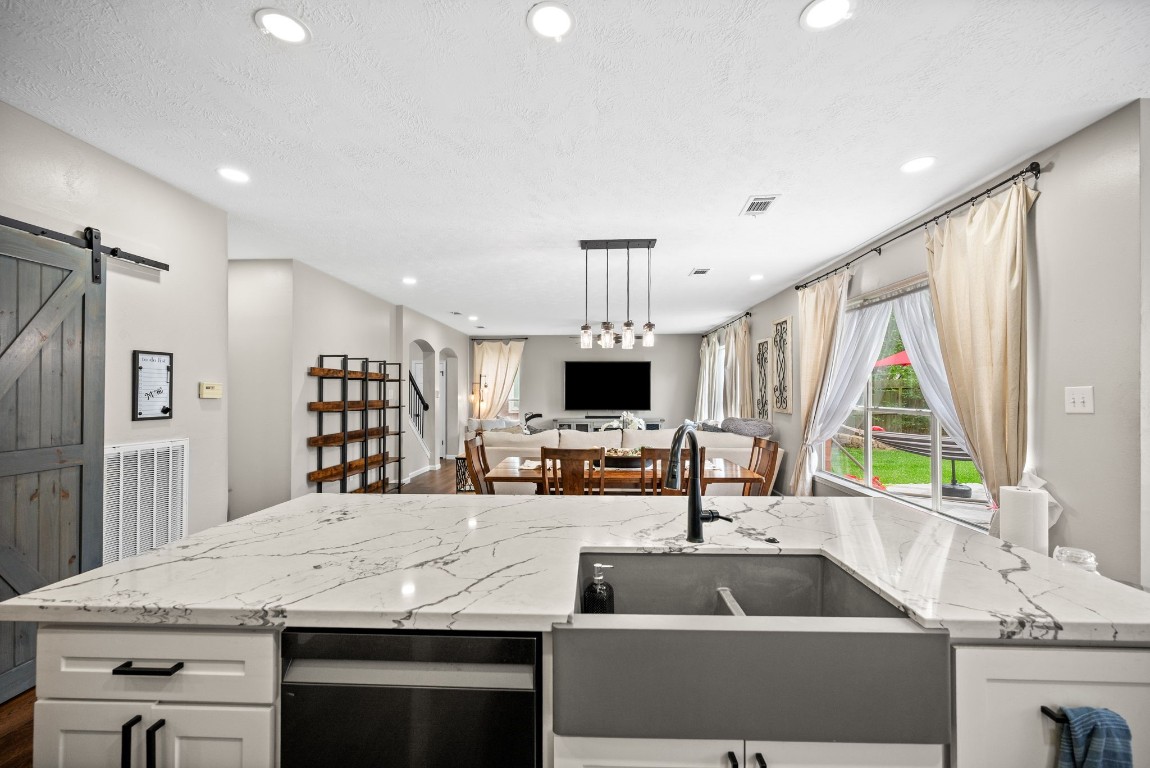814 Legend Spring Drive Katy, TX 77494 - Photo 10 of 30 Catch up on your shows while doing dishes. The expansive island countertop space is perfect for casual meals, buffet style serving, or catching up on homework.