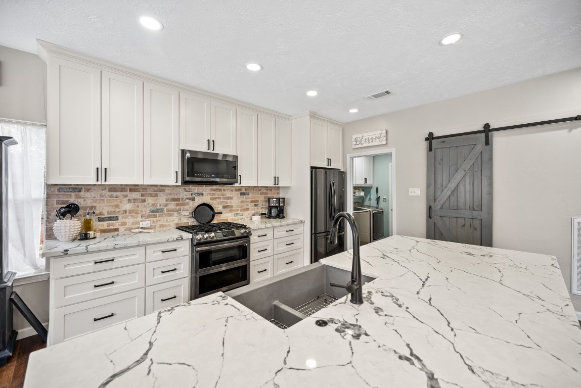 814 Legend Spring Drive Katy, TX 77494 - Photo 13 of 30 Recessed lighting, stainless steel appliances, and expansive countertop space--a kitchen this impressive is a rare find at this price point!