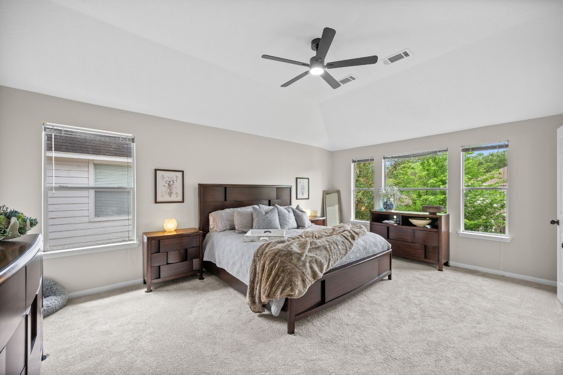 814 Legend Spring Drive Katy, TX 77494 - Photo 15 of 30 The generously sized primary suite is proportioned for King-sized furnishings and enjoys treetop views at the rear of the home.