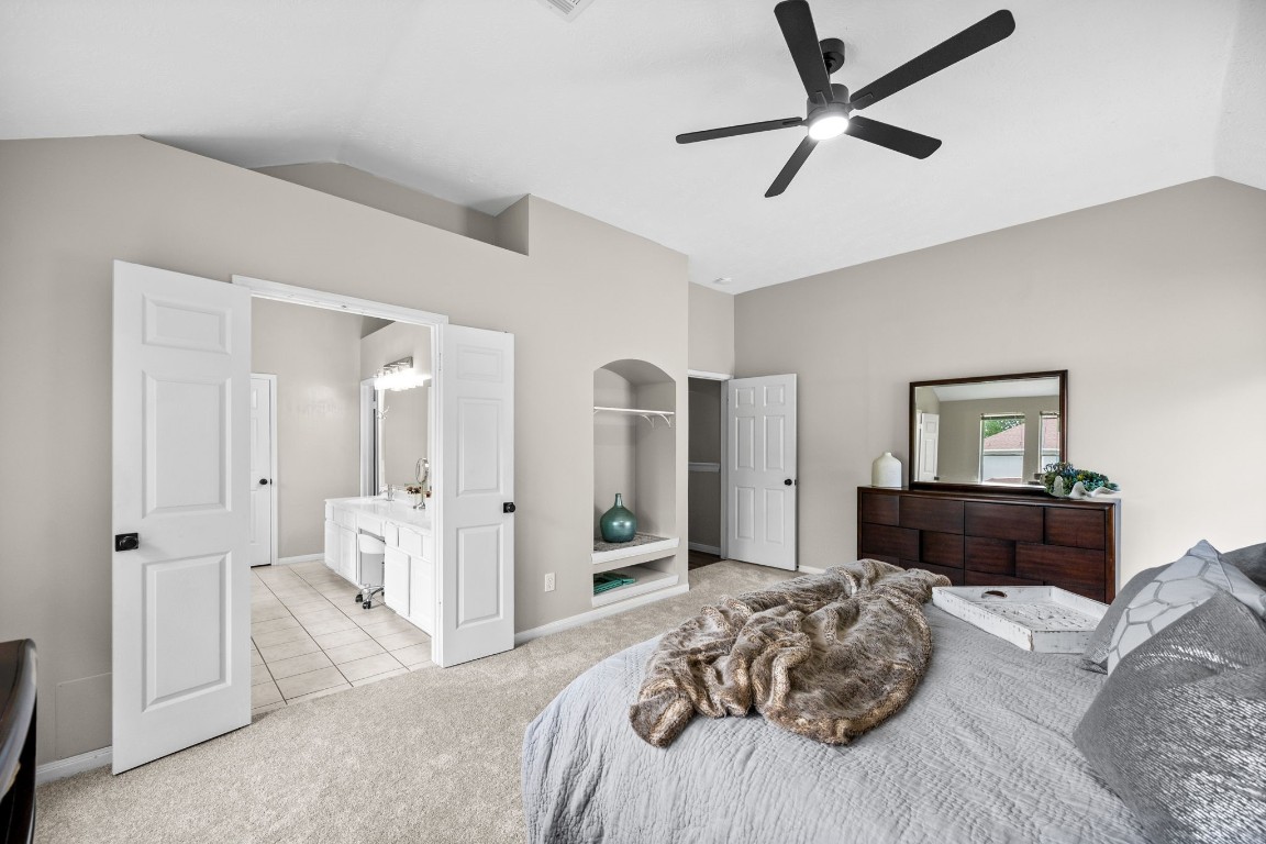 814 Legend Spring Drive Katy, TX 77494 - Photo 16 of 30 From this vantage point, yu can see the double door entry to the primary bath at the left and a storage/display niche to the right. The primary suite is located at the end of the hall, slightly separate from the secondary bedrooms for maximum R&R. The soothing color scheme found throughout the home continues into this serene retreat.