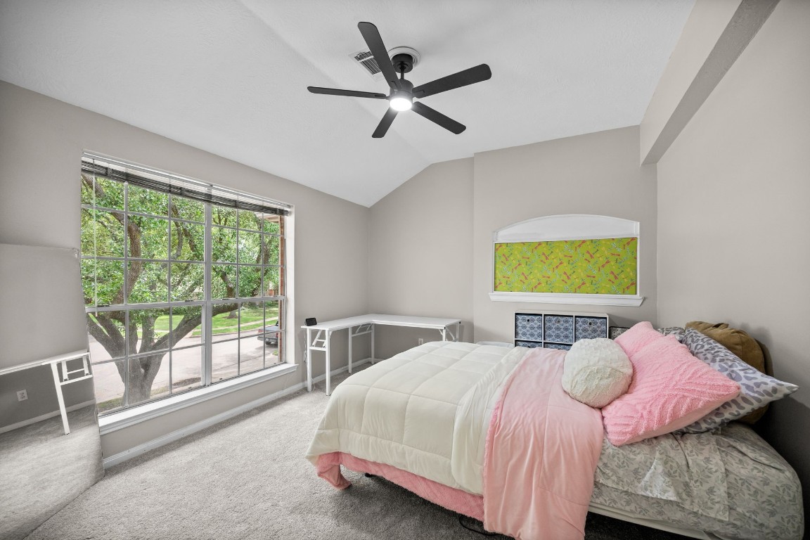 814 Legend Spring Drive Katy, TX 77494 - Photo 19 of 30 Bedroom 2 overlooks the front yard. All of the secondary bedrooms are spacious and can accommodate Queen-sized furnishings. NEW CARPET UPSTAIRS MARCH 2026!