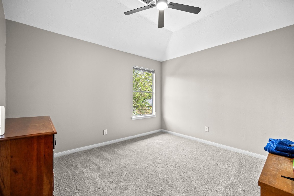 814 Legend Spring Drive Katy, TX 77494 - Photo 20 of 30 Bedroom #3. All of the secondary bedrooms feature spacious closets and treetop views. This bedroom is located at the side of the home.