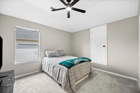 a bedroom with a bed and window