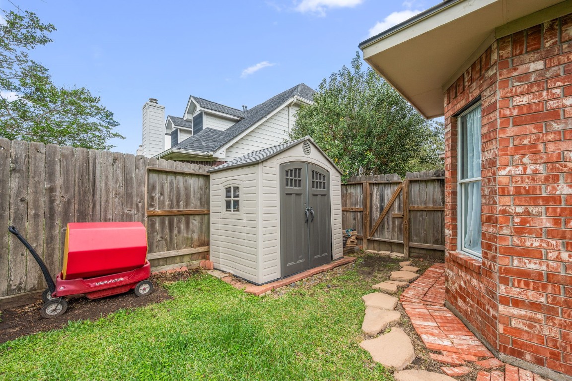 814 Legend Spring Drive Katy, TX 77494 - Photo 28 of 30 This adorable storage shed is in the backyard waiting to house your garden tools or play equipment.