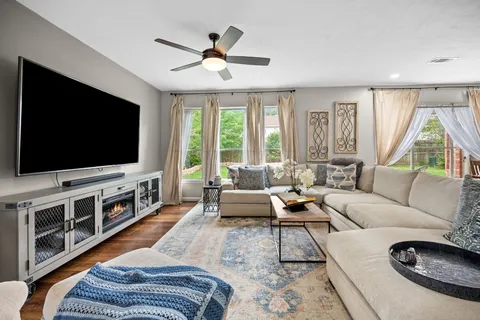 a living room with furniture and a flat screen tv