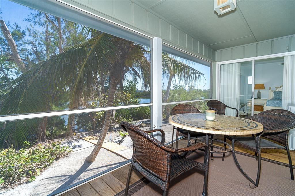 290 South Gulf Boulevard, Unit 31 Placida, FL 33946 - Photo 22 of 63 a view of a porch with furniture and a yard