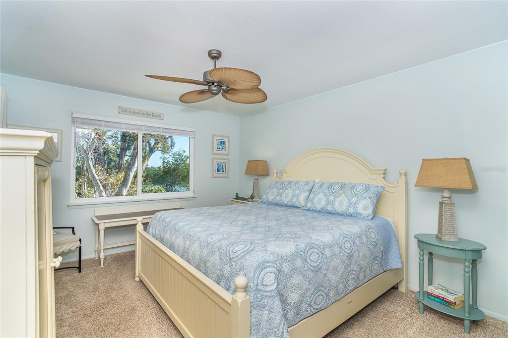290 South Gulf Boulevard, Unit 31 Placida, FL 33946 - Photo 23 of 63 a bedroom with a bed and a chandelier