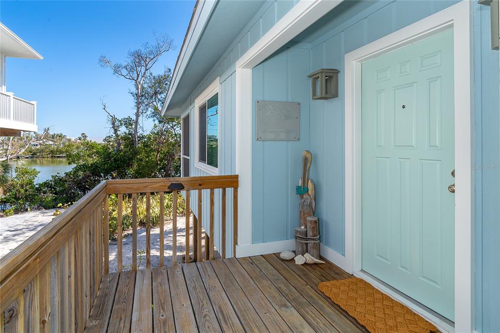 290 South Gulf Boulevard, Unit 31 Placida, FL 33946 - Photo 5 of 63 a view of balcony with wooden floor and fence
