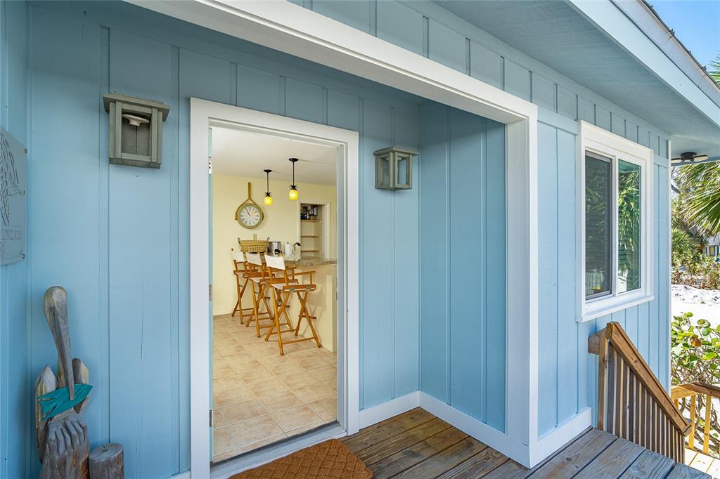 290 South Gulf Boulevard, Unit 31 Placida, FL 33946 - Photo 6 of 63 a view of a hallway with wooden floor and a dining room