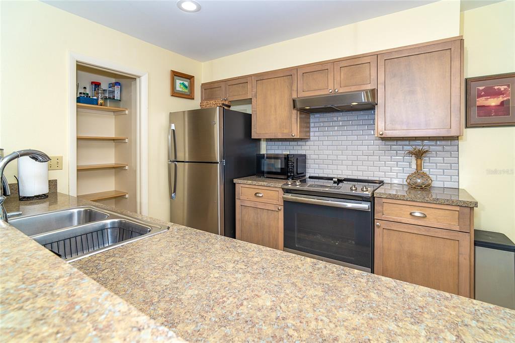 290 South Gulf Boulevard, Unit 31 Placida, FL 33946 - Photo 10 of 63 a kitchen with granite countertop a refrigerator stove and sink