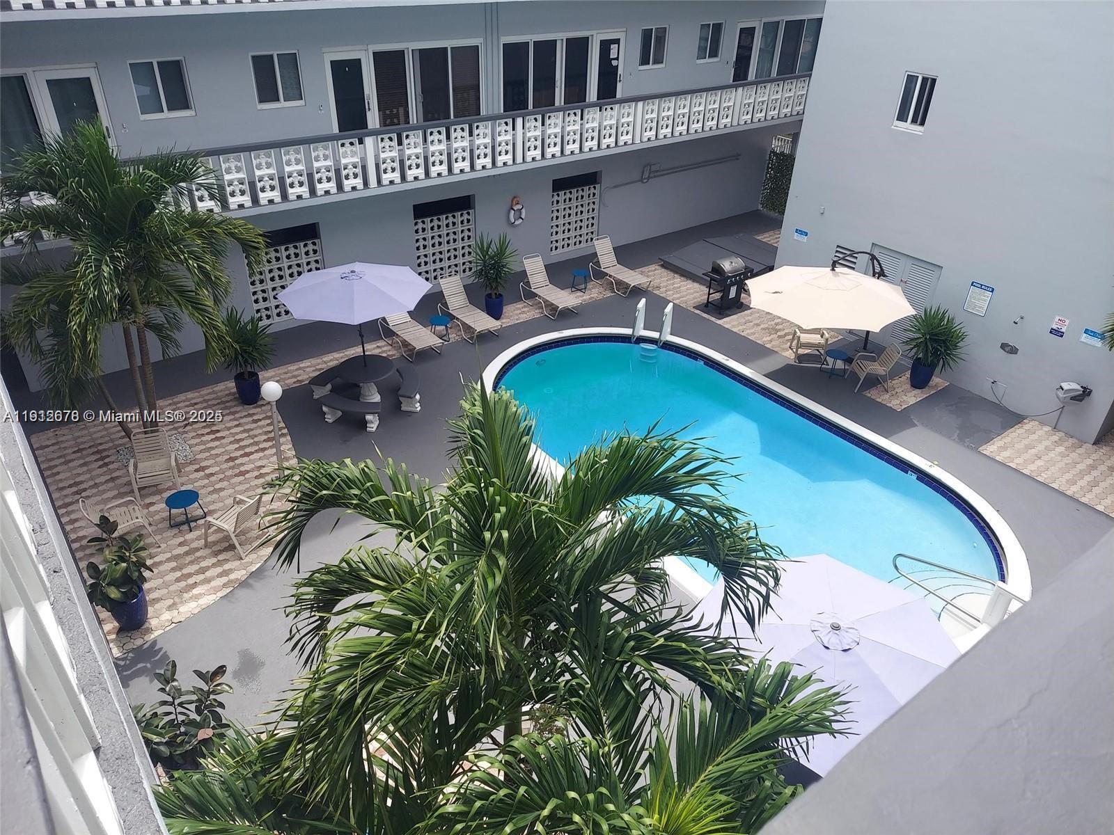 1818 Rodman Street, Unit 4D Hollywood, FL 33020 - Photo 3 of 8 an aerial view of a house with garden space and swimming pool