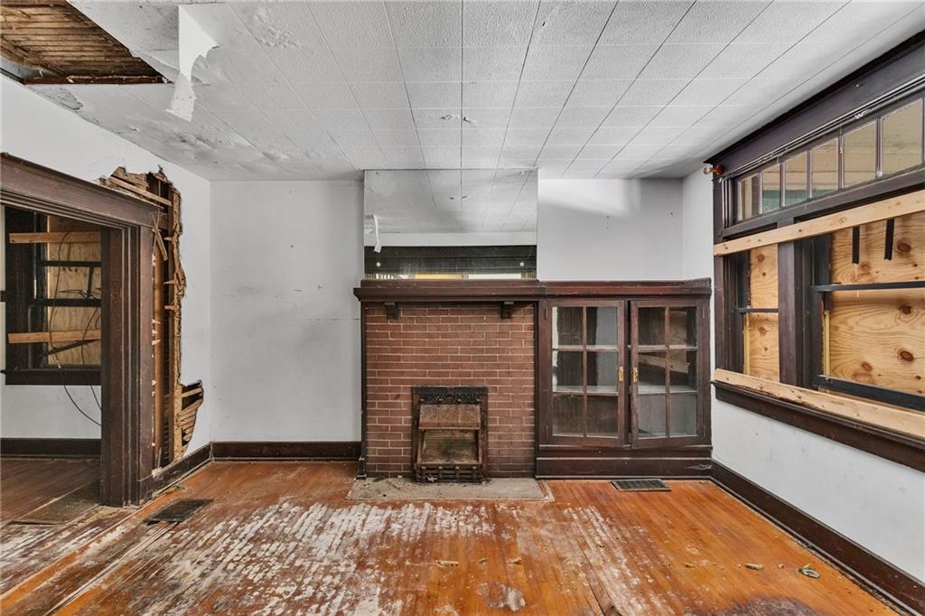 2040 Laketon Road Pittsburgh, PA 15221 - Photo 11 of 26 a view of an empty room with a fireplace and a window