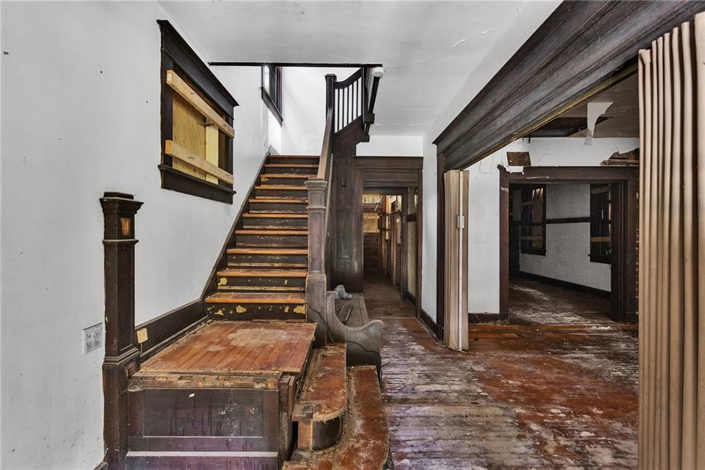 2040 Laketon Road Pittsburgh, PA 15221 - Photo 14 of 26 a view of a livingroom with wooden floor and stairs
