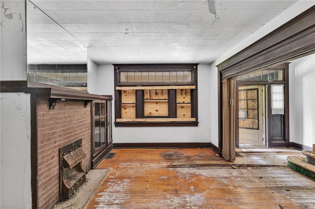 2040 Laketon Road Pittsburgh, PA 15221 - Photo 15 of 26 a view of an empty room with a fireplace and a window