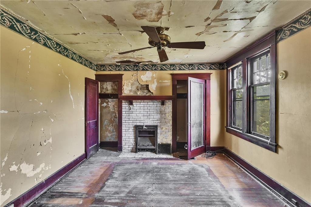 2040 Laketon Road Pittsburgh, PA 15221 - Photo 22 of 26 a view of an empty room with a fireplace and glass windows