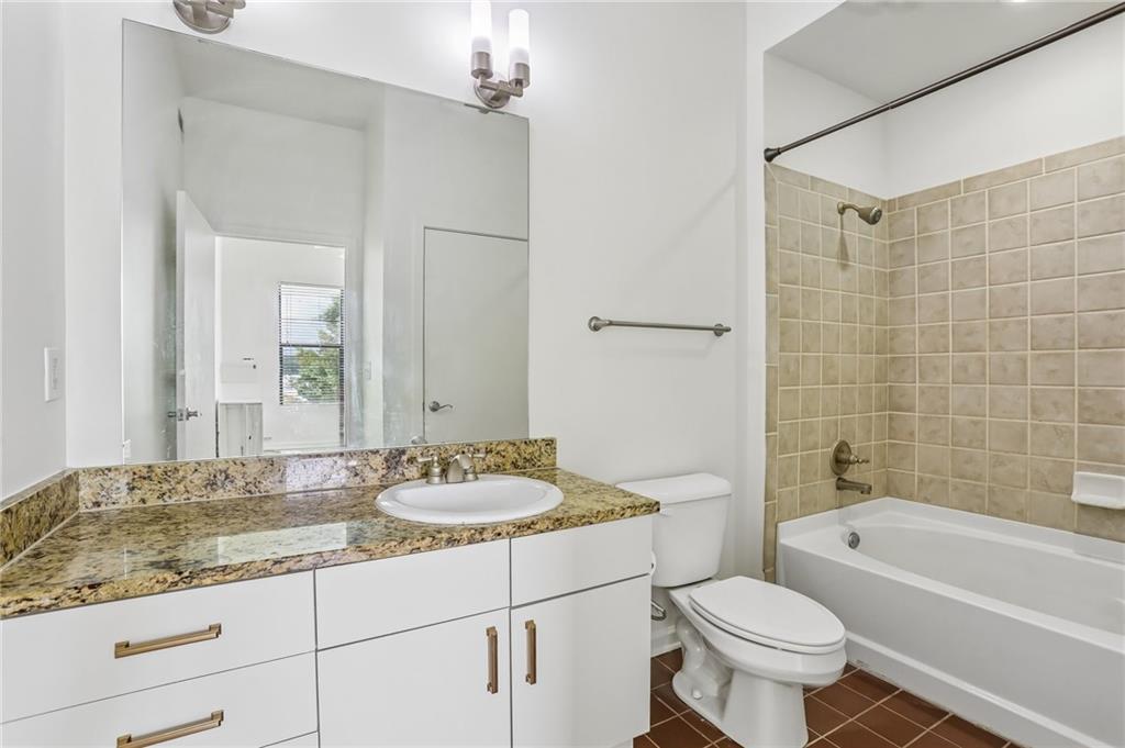 5300 Peachtree Road, Unit 3506 Atlanta, GA 30341 - Photo 13 of 25 a bathroom with a granite countertop sink toilet mirror and bathtub