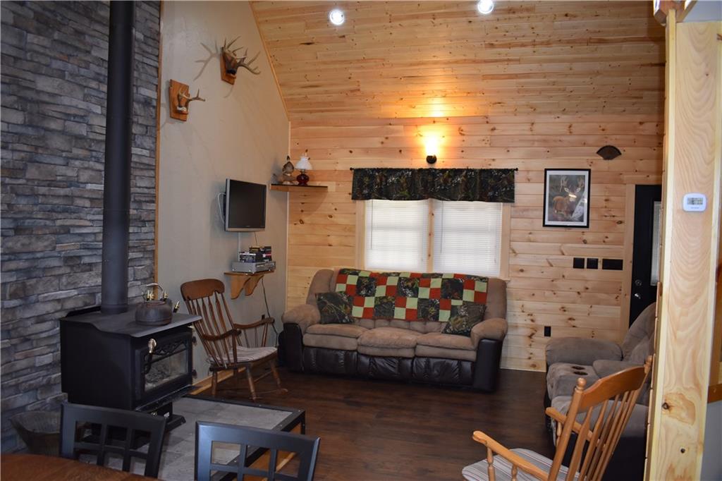 155 Rock Run Road Rector, PA 15677 - Photo 4 of 23 The great room features ample room for entertaining and beautiful stonework behind the wood stove