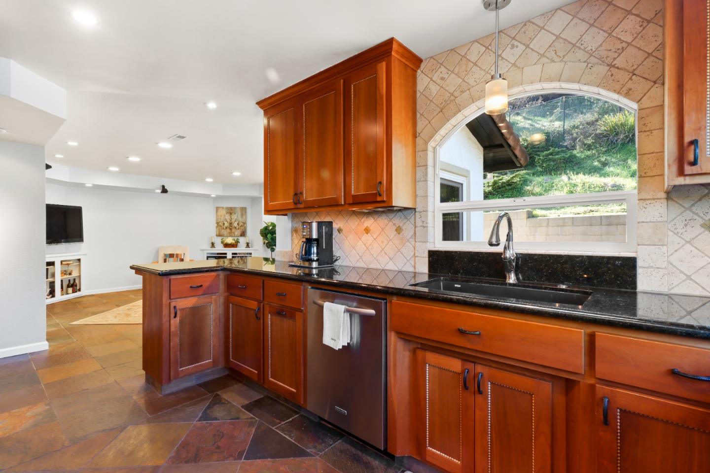 17920 Berta Canyon Road Salinas, CA 93907 - Photo 13 of 36 a kitchen with stainless steel appliances granite countertop wooden cabinets a stove a sink and a large window