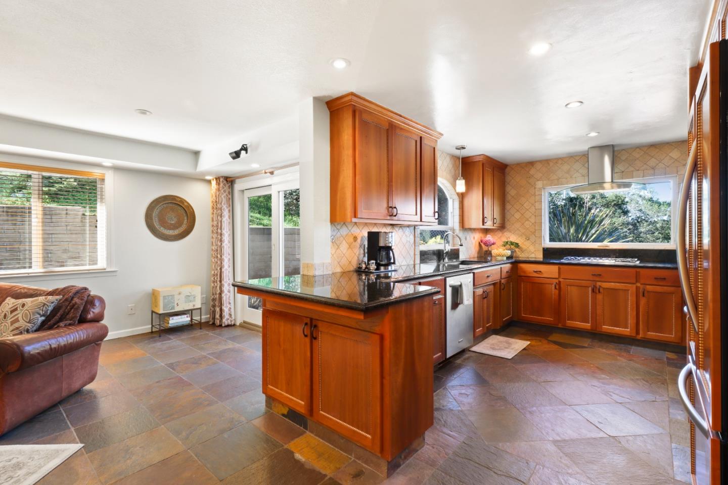17920 Berta Canyon Road Salinas, CA 93907 - Photo 14 of 36 a kitchen with stainless steel appliances granite countertop a stove top oven a sink a counter top space and living room view