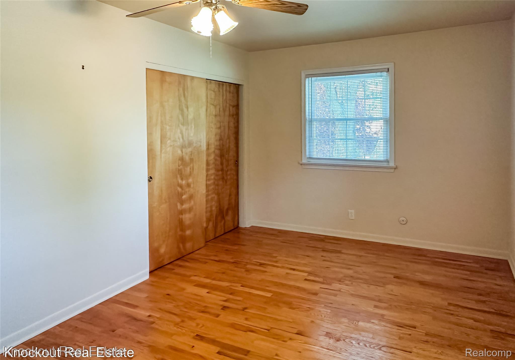 4465 Dirker Road Saginaw, MI 48638 - Photo 27 of 56 Unfurnished bedroom with light wood finished floors, a closet, and a ceiling fan